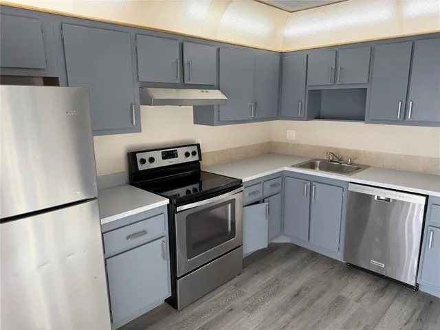 a kitchen with a stove and a refrigerator