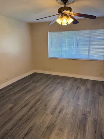 a view of room with wooden floor and fan