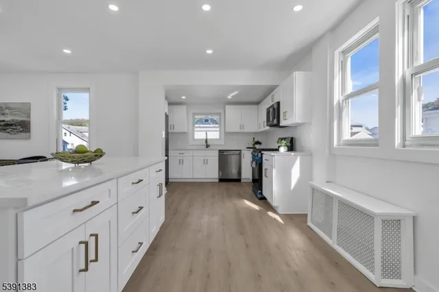 a kitchen with cabinets and wooden floor