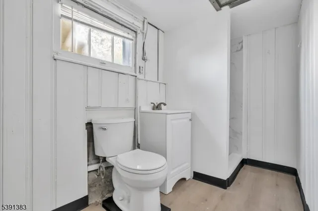 a white toilet sitting next to a bathroom sink