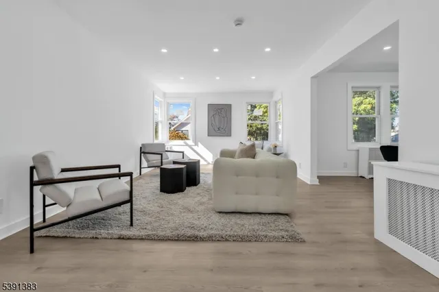 a living room with furniture rug and window