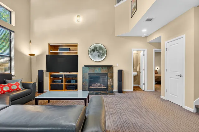 a view of a livingroom with wooden floor and a fireplace