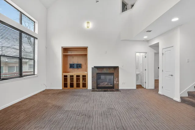 a view of a livingroom with furniture an empty room and wooden floor