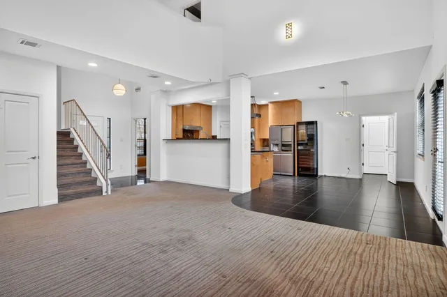 a kitchen with stainless steel appliances granite countertop a sink a stove and a refrigerator