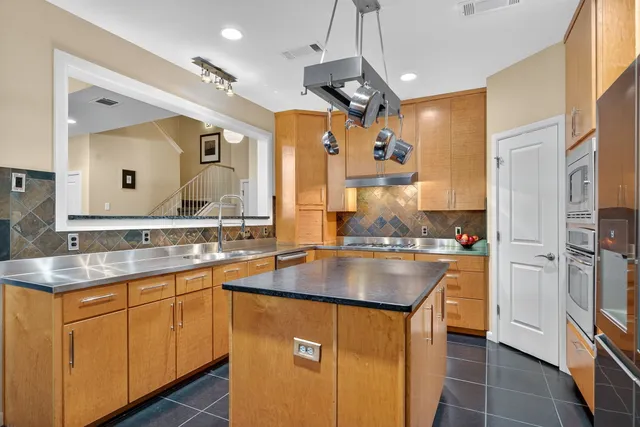 a kitchen with a refrigerator and a stove