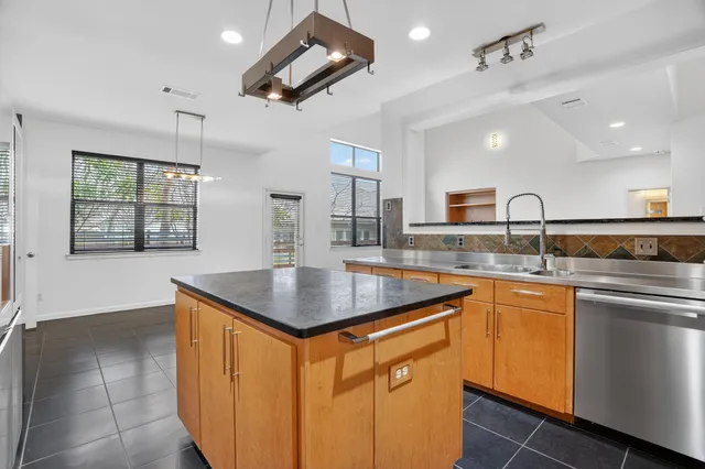 a large kitchen with a table and chairs