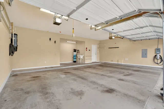 a large kitchen with granite countertop a large counter top stainless steel appliances and cabinets