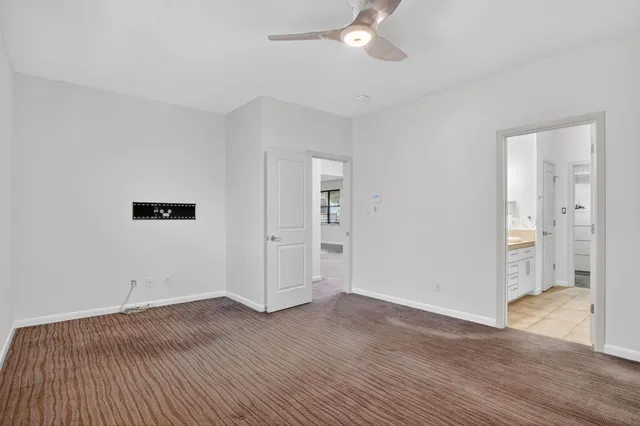 a bathroom with a double vanity sink mirror and next to a window
