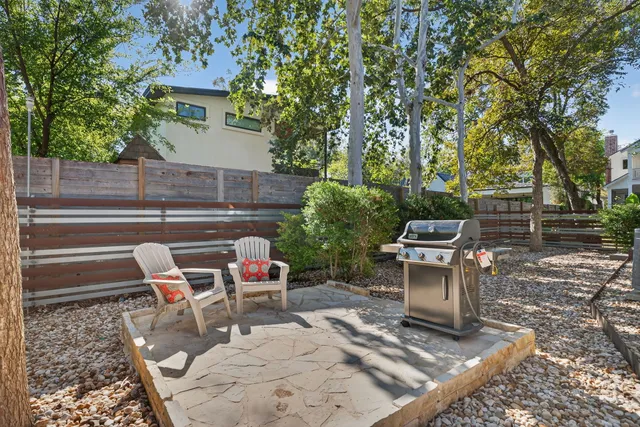 an aerial view of a house with a yard and garden