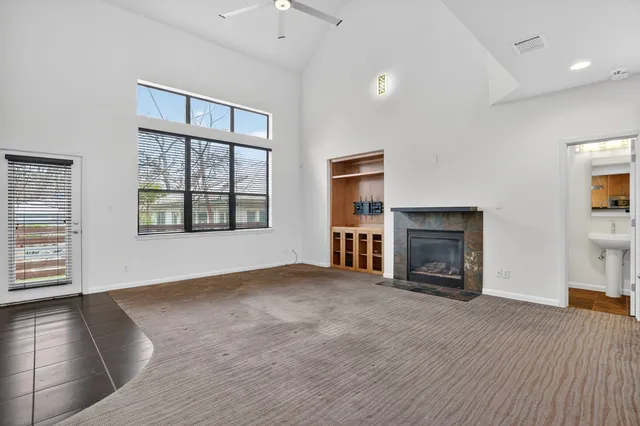 a living room with furniture and a floor to ceiling window