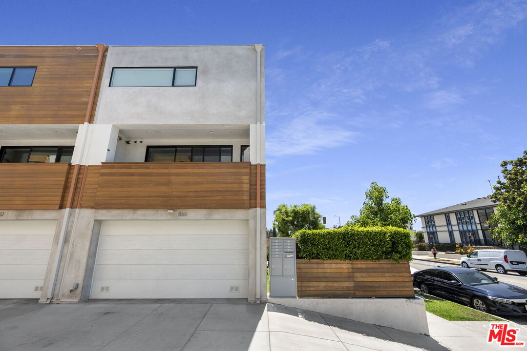 866 South Wilton Place Los Angeles, CA 90005 - Photo 14 of 17 a front view of a house with garage