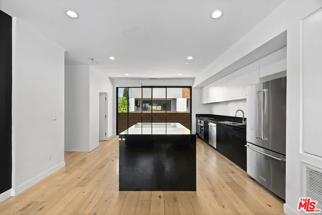 a kitchen with a refrigerator and a sink