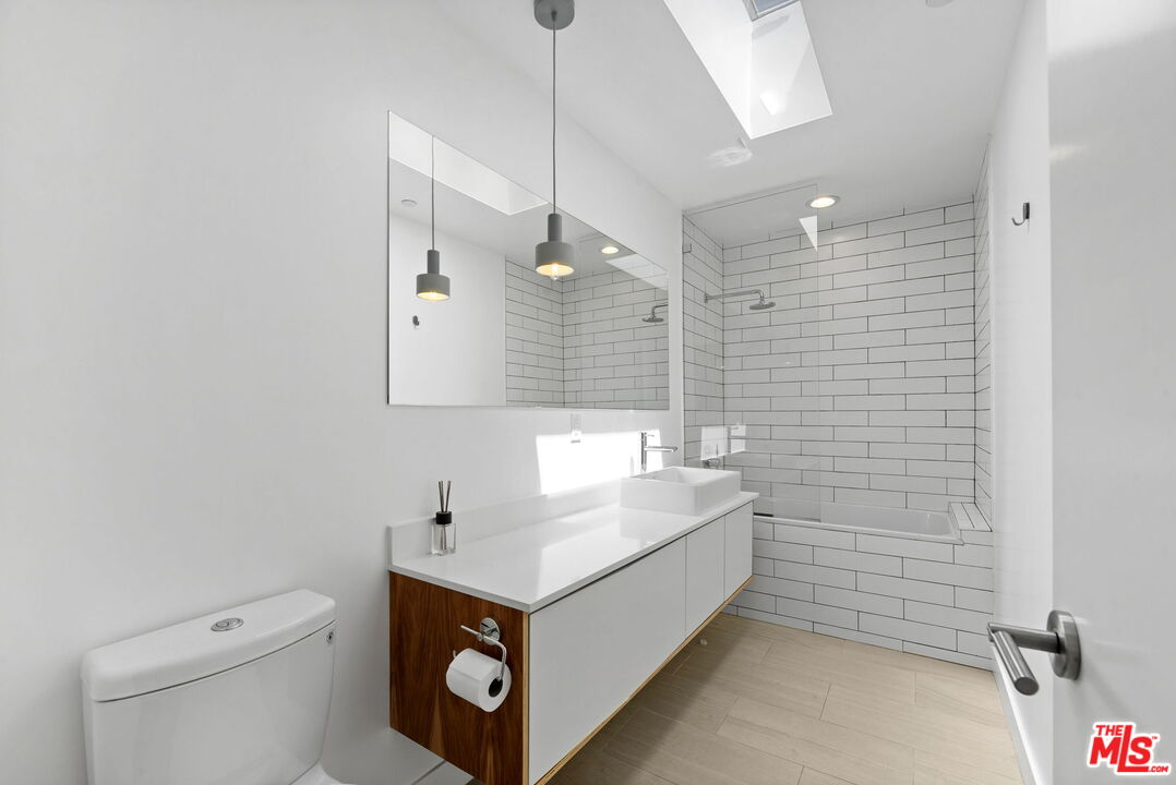 866 South Wilton Place Los Angeles, CA 90005 - Photo 7 of 17 a bathroom with a sink a toilet and shower