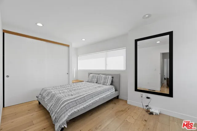 a bedroom with a bed and a window