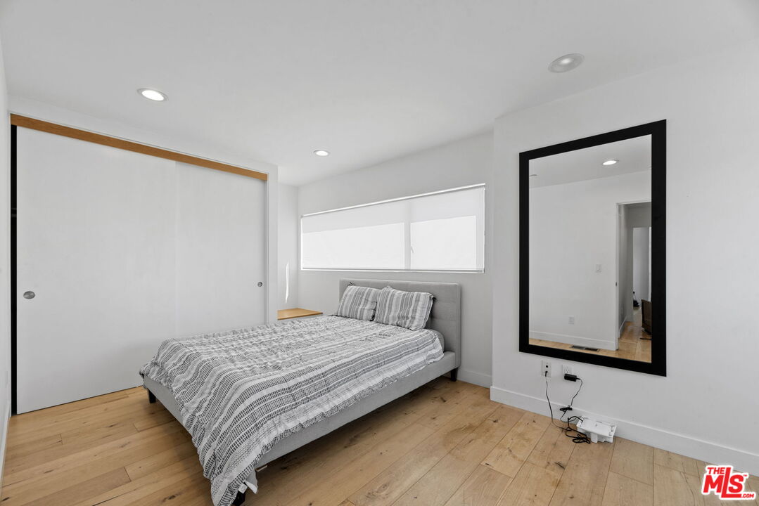 866 South Wilton Place Los Angeles, CA 90005 - Photo 9 of 17 a bedroom with a bed and a window