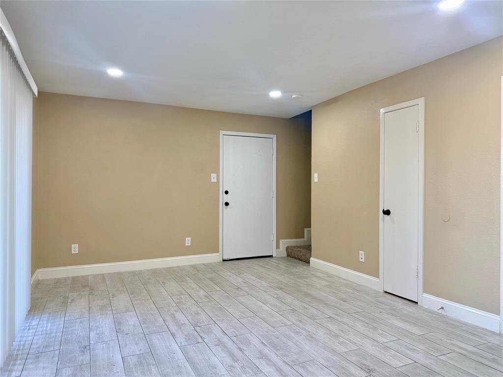 12802 Midway Road, Unit 2015 Dallas, TX 75244 - Photo 4 of 15 Empty room with recessed lighting, wood finish floors, and stairway