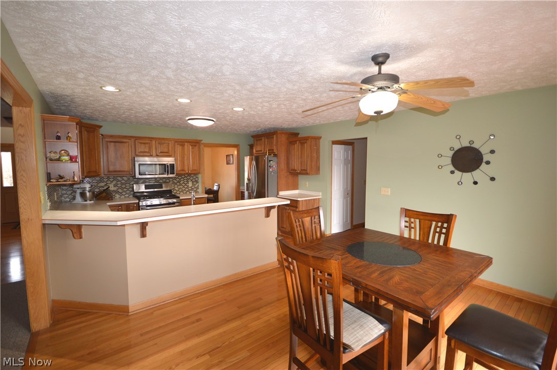 4112 Logans Way Perry, OH 44081 - Photo 13 of 29 Belly up to the breakfast bar to chat with the chef, or sit in the eating area, which overlooks the back yard and pond