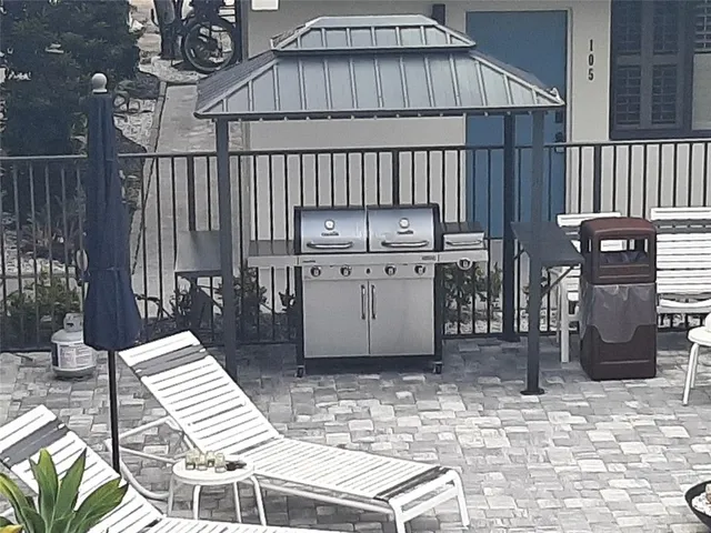 a view of a patio with table and chairs with wooden fence