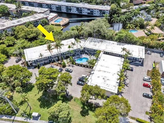 an aerial view of a house with a yard and garden