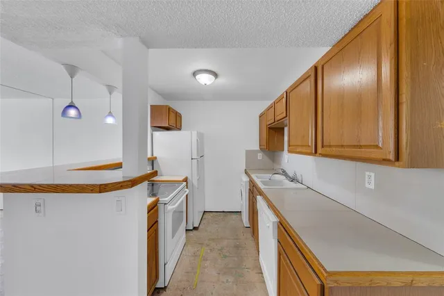 a kitchen with stainless steel appliances granite countertop a sink and a stove