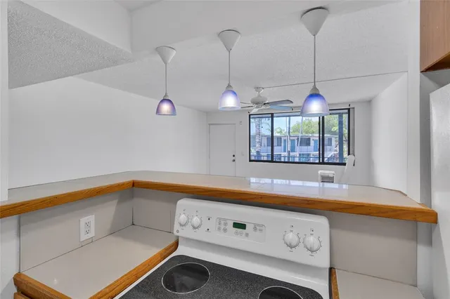 a kitchen with a sink a stove and a window