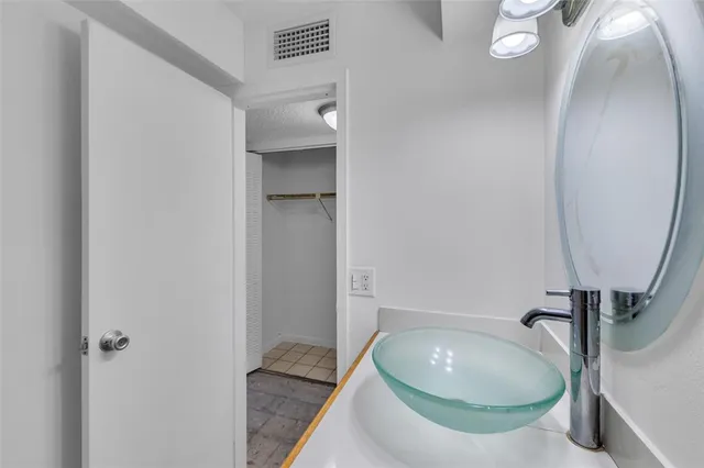 a bathroom with a sink and mirror