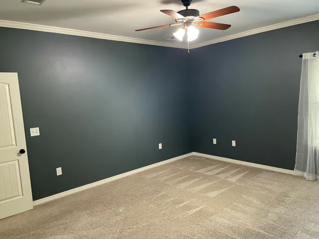 a view of an empty room with a fan