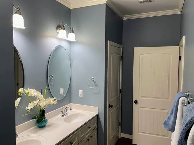 a bathroom with a double vanity sink and a mirror