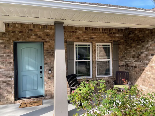 a front view of a house with a garden