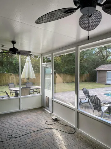 a view of a patio with a table and chairs