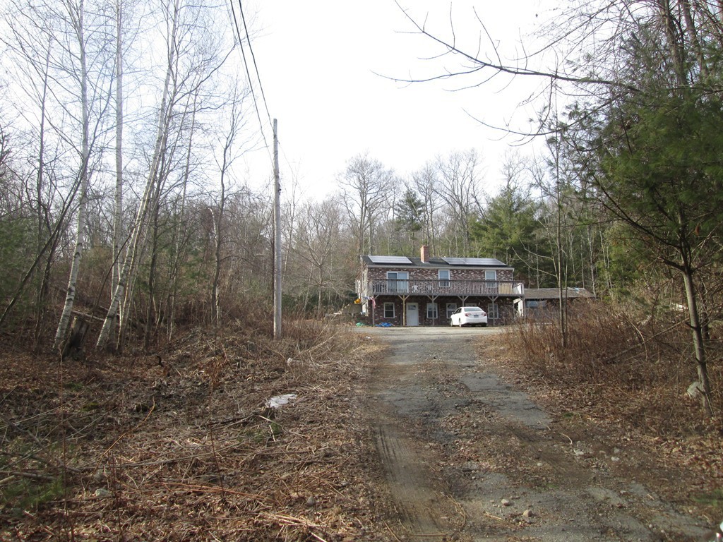 33 Douglas Road Webster, MA 01570 - Photo 2 of 13 a view of house with trees in the background