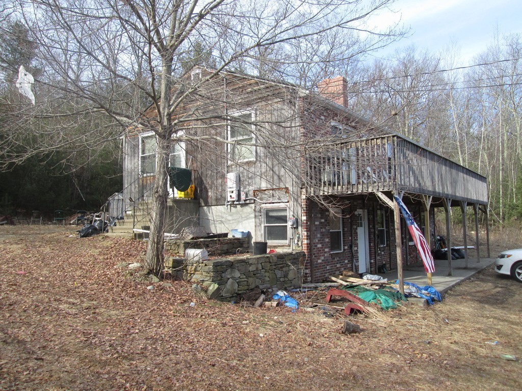 33 Douglas Road Webster, MA 01570 - Photo 3 of 13 a view of a wooden house with large trees