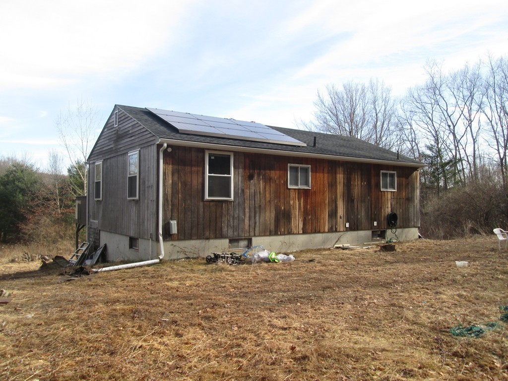 33 Douglas Road Webster, MA 01570 - Photo 4 of 13 a front view of a house with a yard