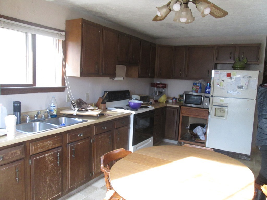 33 Douglas Road Webster, MA 01570 - Photo 9 of 13 a kitchen with stainless steel appliances granite countertop a sink stove and refrigerator
