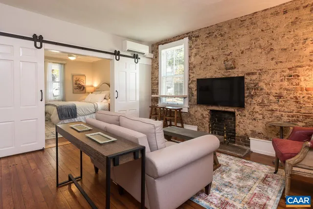 a living room with furniture a flat screen tv and a fireplace
