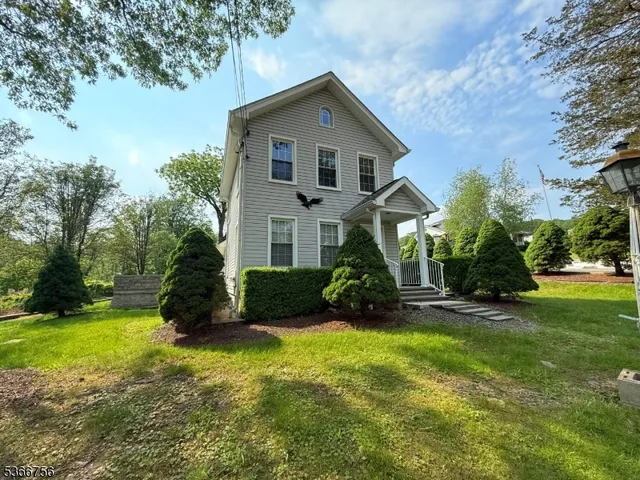 a front view of a house with yard and green space