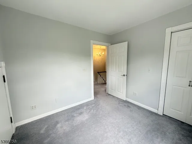 an empty room with closet and mirror