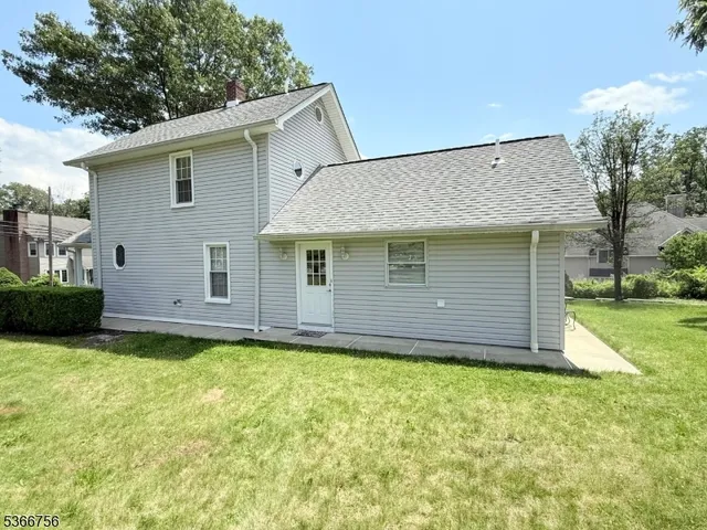 a front view of house with yard and garage