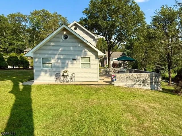 a view of a house with pool and sitting area