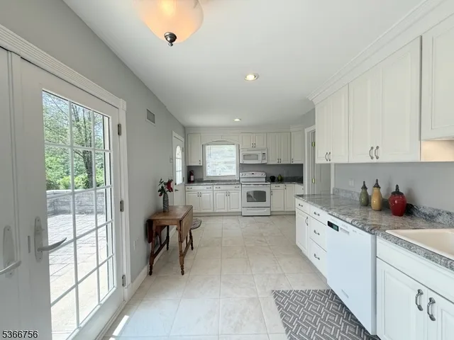 a kitchen that has a lot of cabinets in it and appliances
