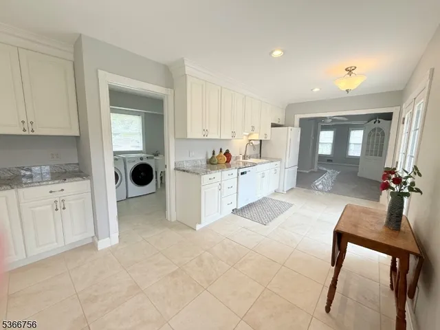 a view of a kitchen with furniture and cabinets