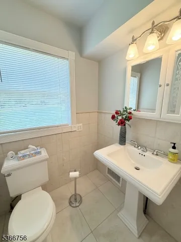 a white toilet sitting next to a bathroom sink