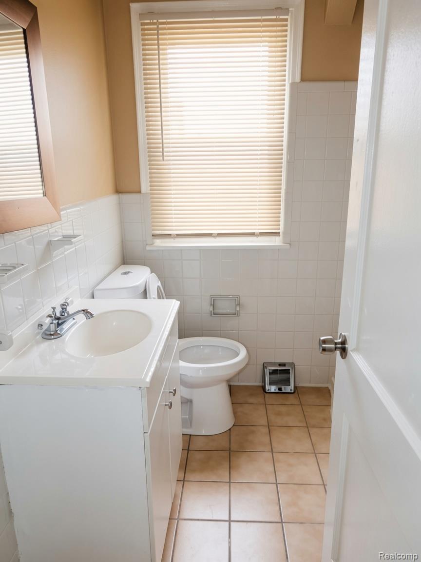 16069 Liberal Street Detroit, MI 48205 - Photo 5 of 9 Bathroom featuring a white vanity with integrated sink, chrome faucet, and tiled flooring