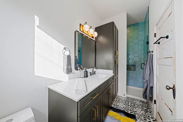 a bathroom with a sink a mirror and a shower