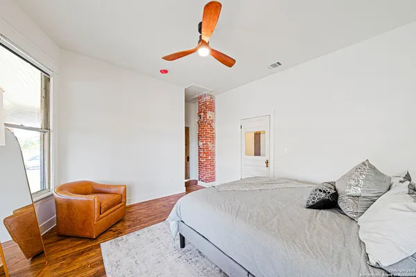 a bedroom with a bed and couch