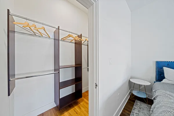 a view of walk in closet with empty racks