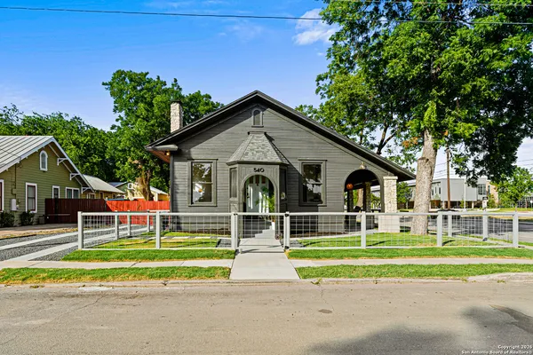 a front view of a house with a yard table and chairs