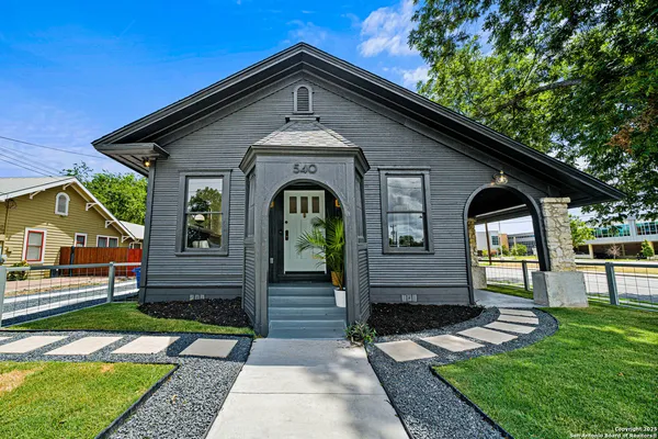 a front view of a house with garden