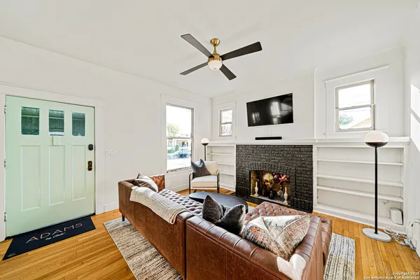 a living room with furniture fireplace and a flat screen tv