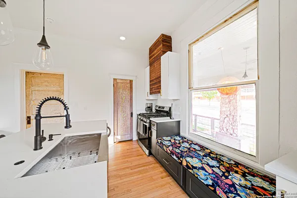 a living room with furniture fireplace and wooden floor